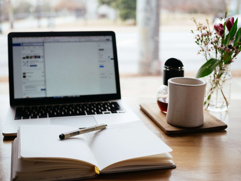 laptop, book and pen